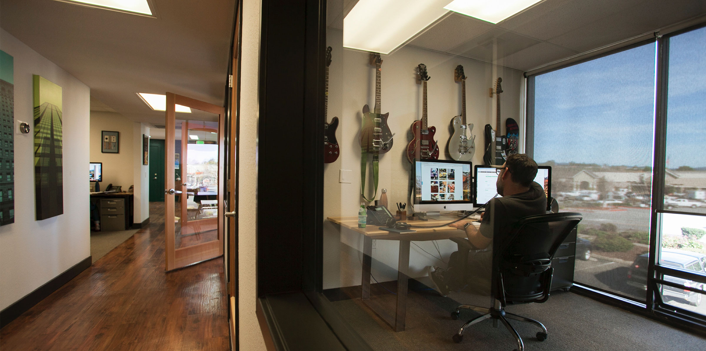 jon in his office full of guitars