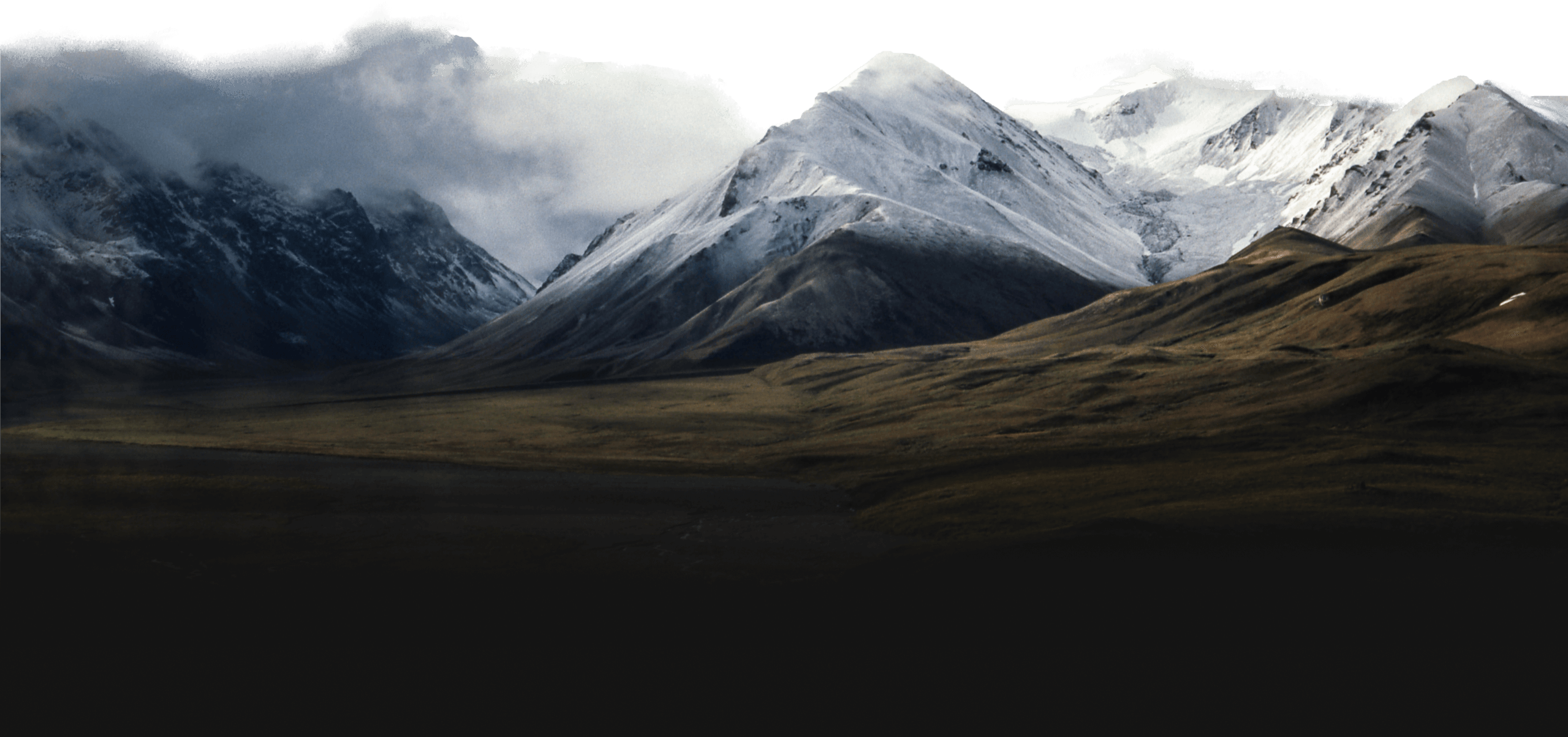 Rolling hills leading into snow capped mountains